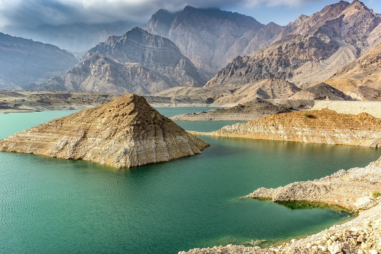 Mountain range on coast, turquoise sea and sandy mountain slopes