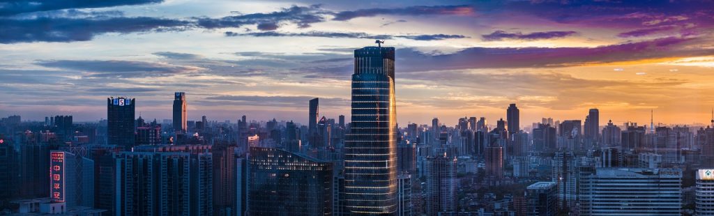 panorama bild der skyline von guangzhou, blick auf wolkenkratzer der stadt vor lila-gelbem sonnenuntergang