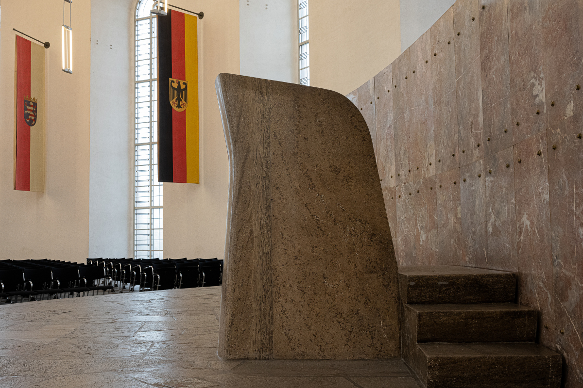 Raum des Wortes Rednerpult aus Muschelkalk mit den Fahnen Deutschlands und Hessen